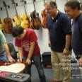 Andreas Varady signs Benedetto Guitar back Sept 2012 as Bob Benedetto Howard Paul Dave Miner look on