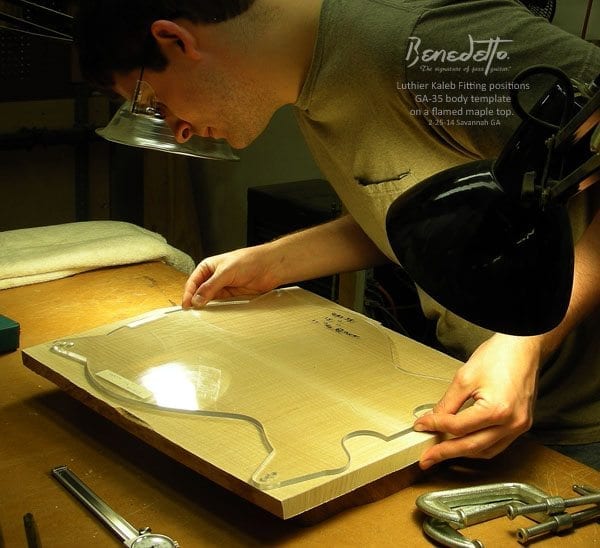 Kaleb Fitting  positioning the GA-35 body template on a flamed maple top 2-25-14 _2a news