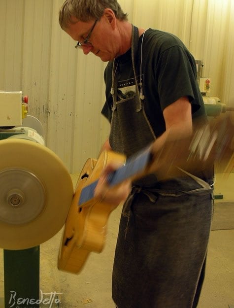 Master Finisher Larry Perkins buffs a Cremona archtop Benedetto Guitars 12-3-14 photo by Stephanie Ward